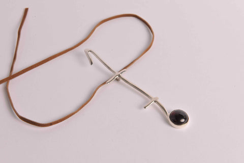 Pendant in sterling silver on leather thong necklace